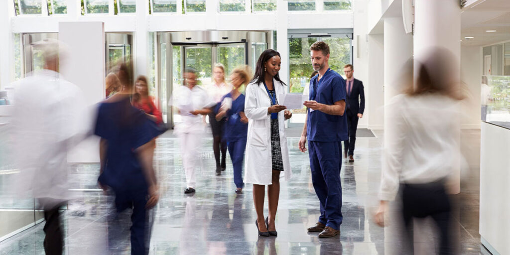 Doctor showing a document to a nurse.