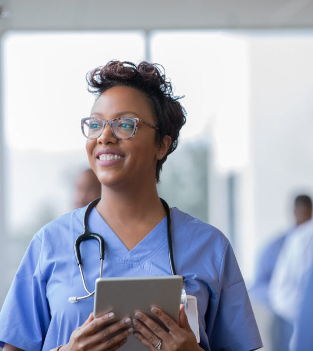 Medical professional holding tablet.