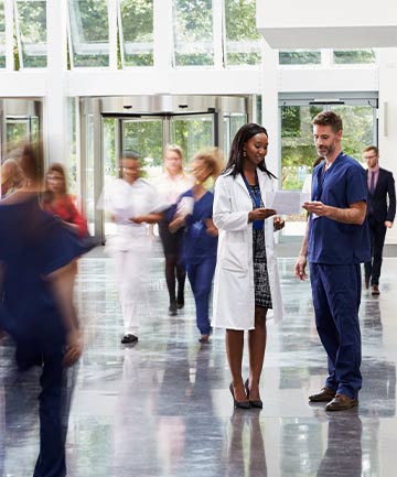 Medical professionals discuss information on a piece of paper.