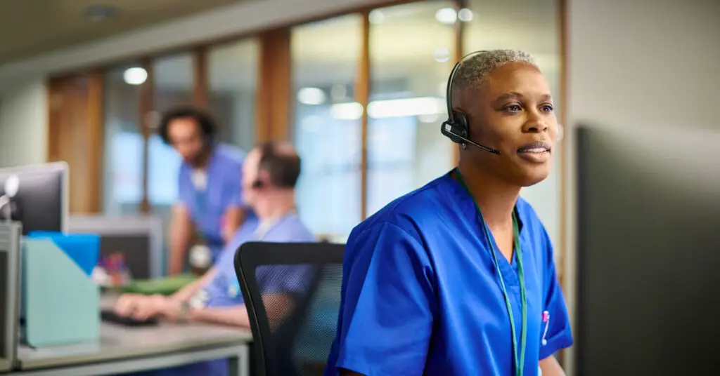 hospital at home nurse in a hospital call center converses with a patient via headset