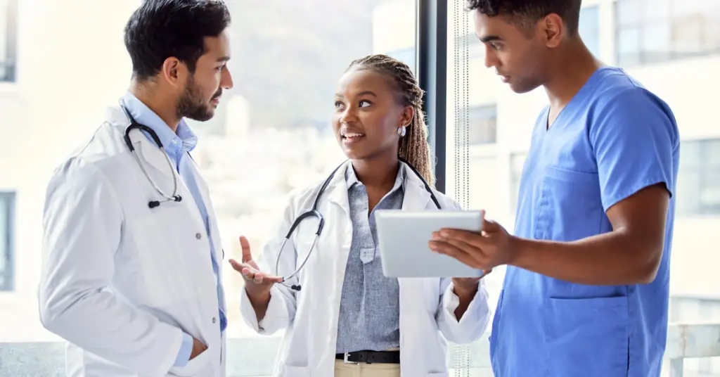 Three medical professionals talking in hospital